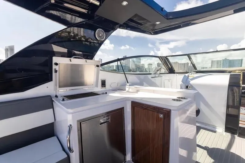 Slide: The Image of 2021 Cruisers Yachts 38 GLS OB interior with kitchenette and city skyline view. - 15