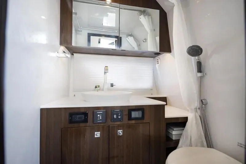 Slide: The Image of Luxurious bathroom in 2021 Cruisers Yachts 38 GLS OB with modern fixtures and wood cabinetry. - 27