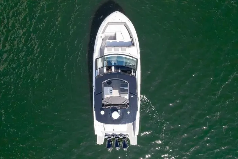 Slide: The Image of Aerial view of 2021 Cruisers Yachts 38 GLS OB on green water. - 3