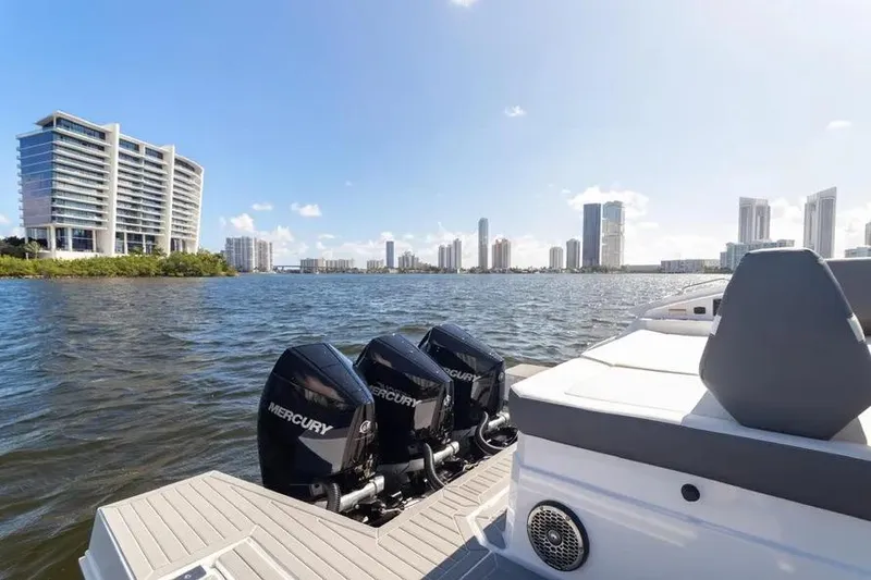 Slide: The Image of 2021 Cruisers Yachts 38 GLS OB on water with city skyline in background. - 14