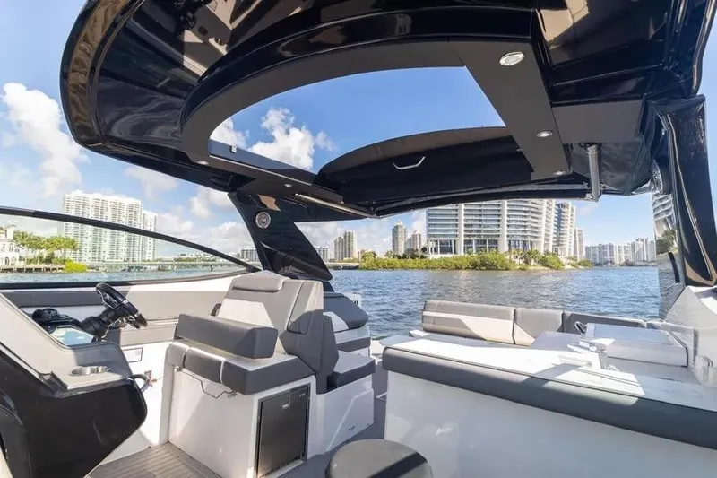 Slide: The Image of 2021 Cruisers Yachts 38 GLS OB on water, modern interior, city skyline background. - 22