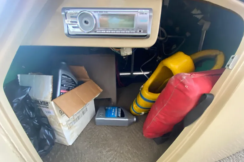 Slide: The Image of Storage compartment of a 2012 Bennington 2575 QCW I/O with supplies and life jackets. - 10