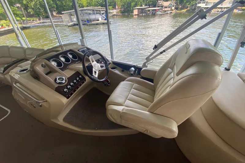 Slide: The Image of 2012 Bennington 2575 QCW I/O boat interior with steering wheel and comfortable seating. - 13