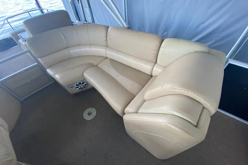 Slide: The Image of Luxurious beige seating on 2012 Bennington 2575 QCW I/O boat, featuring plush upholstery. - 16