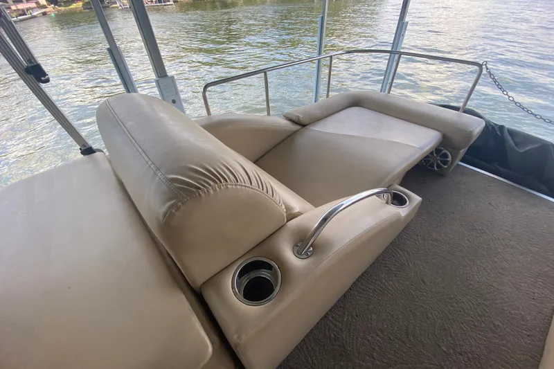 Slide: The Image of Luxurious seating on 2012 Bennington 2575 QCW I/O boat with cup holders and lake view. - 18
