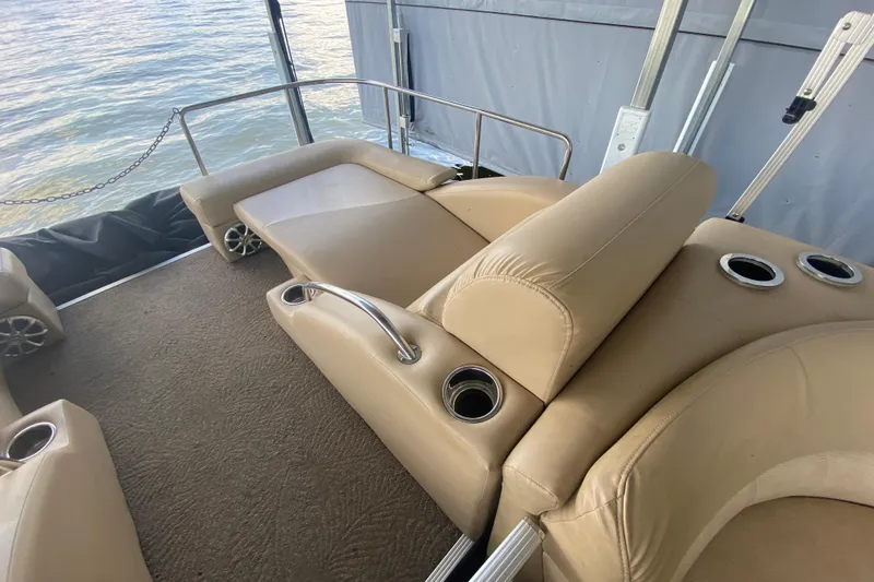 Slide: The Image of Luxurious seating on 2012 Bennington 2575 QCW I/O boat with cup holders and water view. - 19