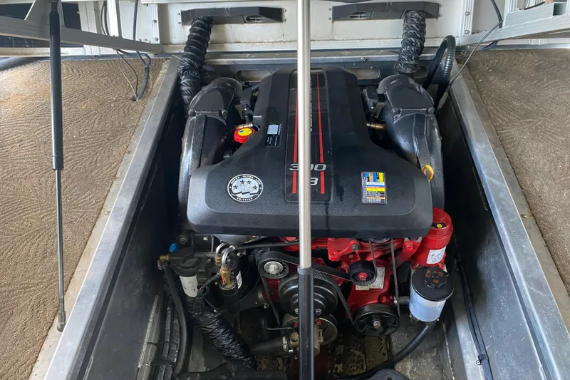 Slide: The Image of Engine compartment of a 2012 Bennington 2575 QCW I/O boat, showcasing a powerful motor. - 23