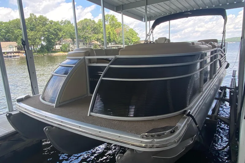 Slide: The Image of 2012 Bennington 2575 QCW I/O pontoon boat docked on a sunny day. - 26