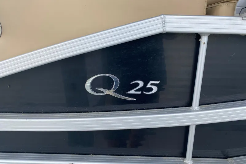 Slide: The Image of 2012 Bennington 2575 QCW I/O boat with "Q25" emblem on the side. - 4
