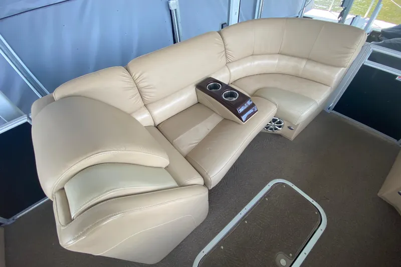 Slide: The Image of Luxurious beige seating on 2012 Bennington 2575 QCW I/O boat with cup holders. - 6