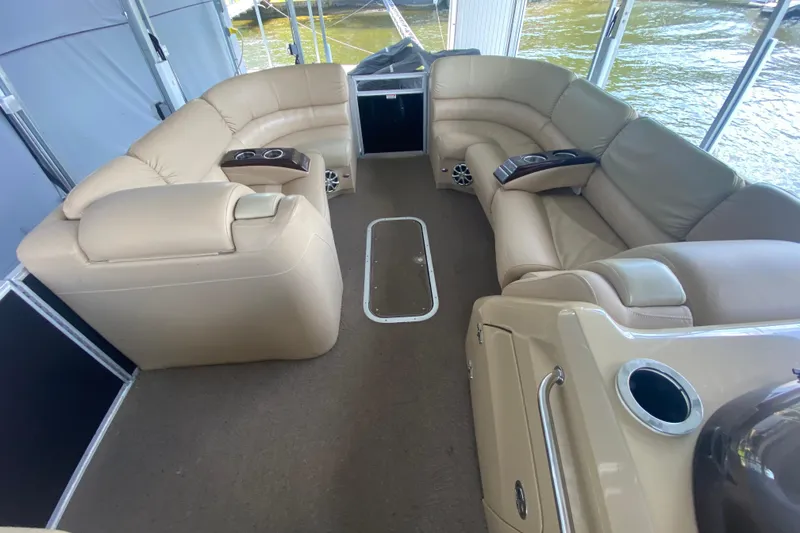 Slide: The Image of Luxurious interior of 2012 Bennington 2575 QCW I/O pontoon boat with beige seating. - 8