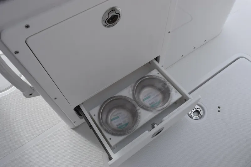 Slide: The Image of Storage drawer with pet bowls on 2026 Sea Hunt Ultra 285 SE boat. - 16
