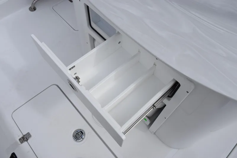 Slide: The Image of Open storage drawer on 2026 Sea Hunt Ultra 285 SE boat, showcasing interior compartments. - 18