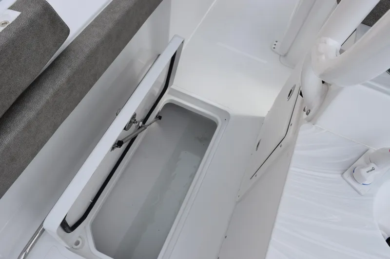 Slide: The Image of 2026 Sea Hunt Ultra 285 SE boat storage compartment with open lid. - 23