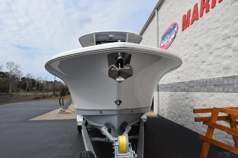 Slide: The Image of 2026 Sea Hunt Ultra 285 SE boat on trailer outside marine store. - 3