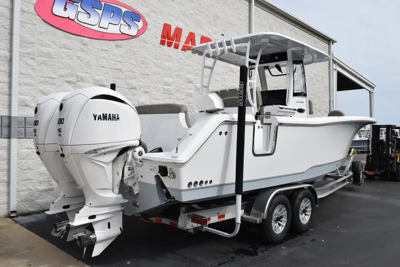 Slide: The Image of 2026 Sea Hunt Ultra 285 SE boat with dual Yamaha engines on a trailer. - 4