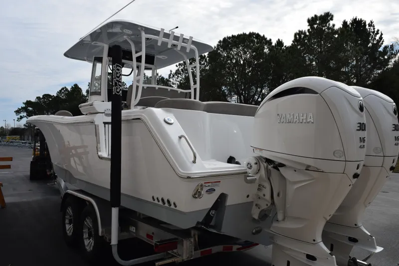 Slide: The Image of 2026 Sea Hunt Ultra 285 SE boat with dual Yamaha engines on a trailer. - 6