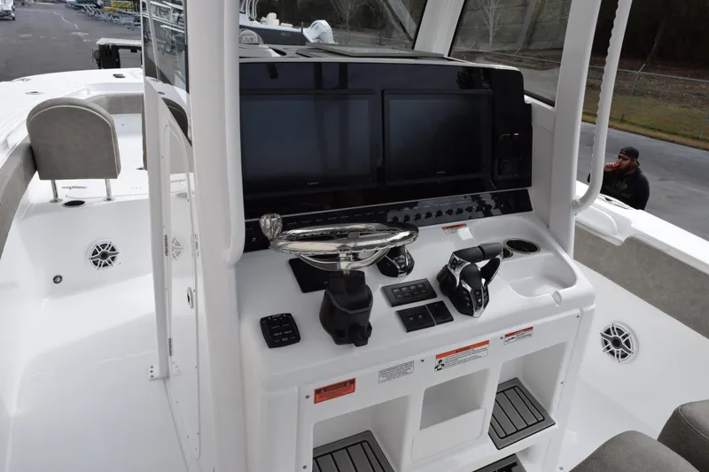 Slide: The Image of 2026 Sea Hunt Ultra 285 SE boat console with dual screens and controls. - 9