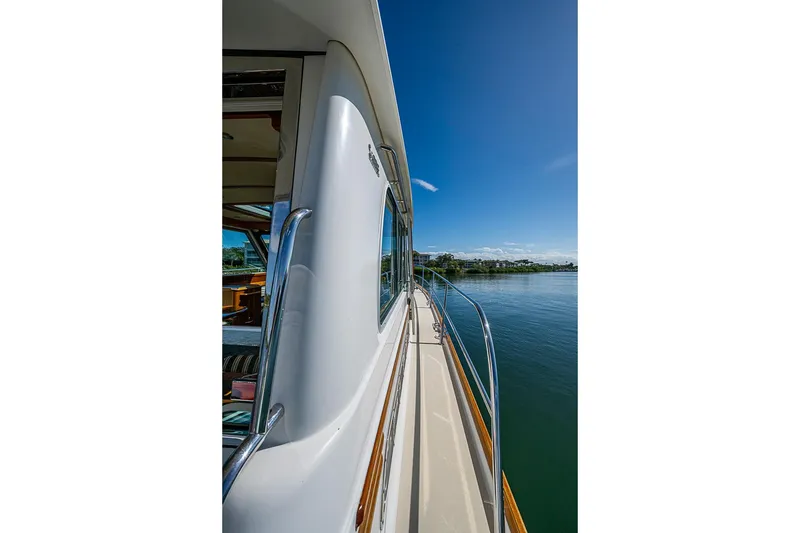 Slide: The Image of 2016 Sabre 42 Salon Express yacht on calm water under clear blue sky. - 11