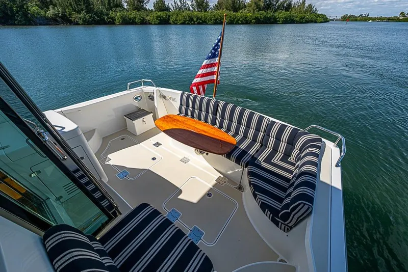 Slide: The Image of 2016 Sabre 42 Salon Express yacht deck with striped seating and American flag. - 14