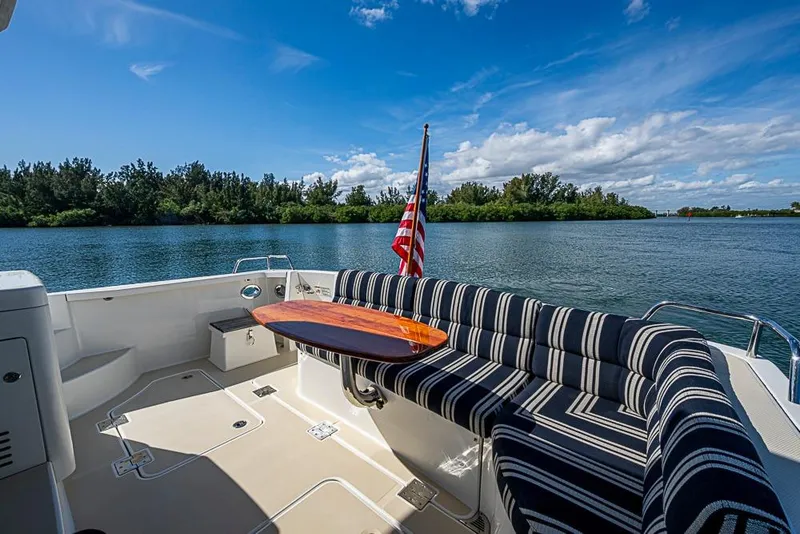 Slide: The Image of 2016 Sabre 42 Salon Express yacht deck with striped seating and American flag. - 16