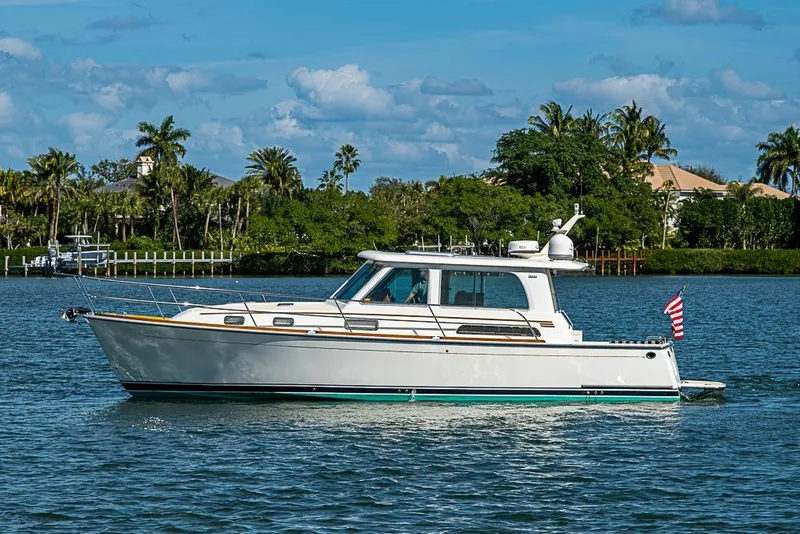 Slide: The Image of 2016 Sabre 42 Salon Express yacht cruising on a scenic waterway. - 2