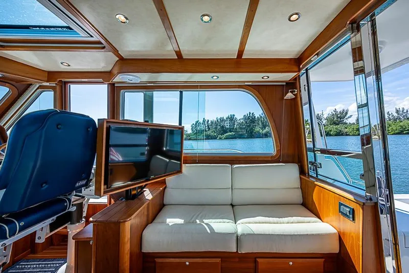 Slide: The Image of Luxurious interior of 2016 Sabre 42 Salon Express yacht with sofa and TV, overlooking water. - 20