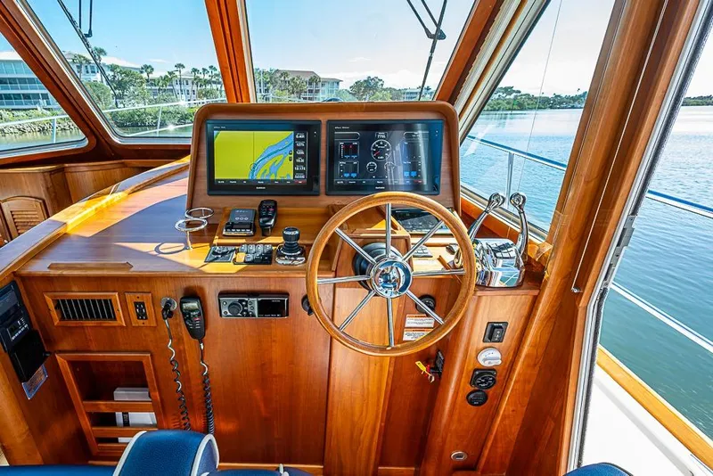 Slide: The Image of 2016 Sabre 42 Salon Express helm with navigation screens and wooden steering wheel. - 25