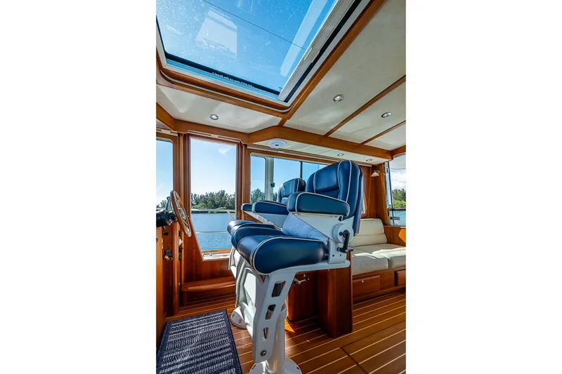 Slide: The Image of Interior of 2016 Sabre 42 Salon Express yacht with blue captain's chairs and panoramic windows. - 26