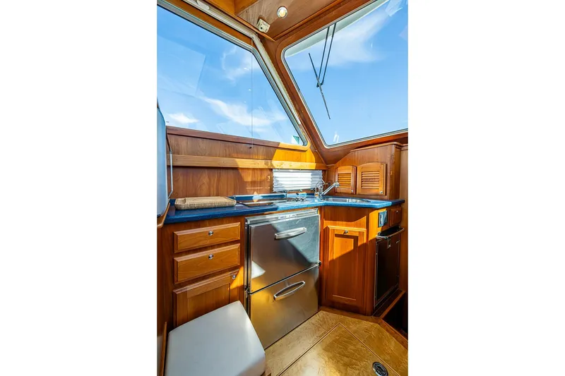 Slide: The Image of Interior of 2016 Sabre 42 Salon Express yacht with wooden cabinetry and modern appliances. - 28