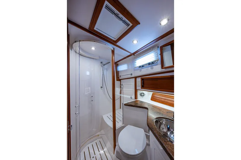 Slide: The Image of Luxurious bathroom in 2016 Sabre 42 Salon Express yacht with modern fixtures and wood accents. - 40