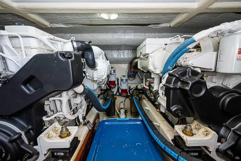 Slide: The Image of Engine room of 2016 Sabre 42 Salon Express with dual engines and blue hoses. - 42