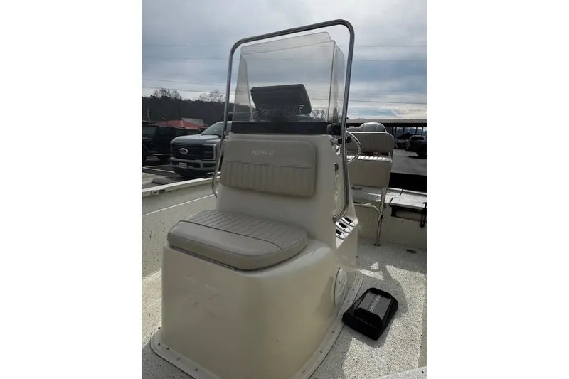 Slide: The Image of 2017 Xpress H20B Bay boat interior with seating and console, parked outdoors. - 5