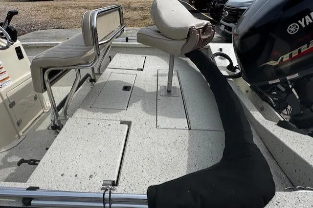 Slide: The Image of 2017 Xpress H20B Bay boat interior with Yamaha engine, featuring seating and storage compartments. - 8