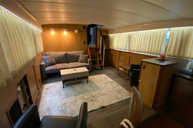 Slide: The Image of Interior of 1977 Bertram 42 Flybridge Motor Yacht with cozy seating and modern decor. - 16