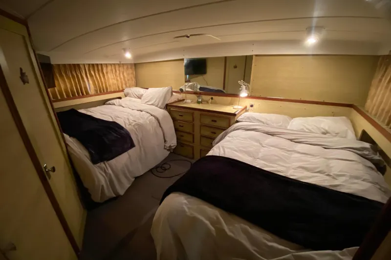 Slide: The Image of Cozy bedroom in 1977 Bertram 42 Flybridge Motor Yacht with twin beds and warm lighting. - 20