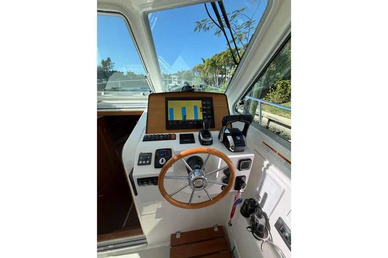 Slide: The Image of 2023 Back Cove 340 helm with modern controls and navigation display. - 11