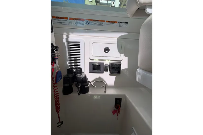Slide: The Image of 2023 Back Cove 340 boat interior with control panel and binoculars. - 14