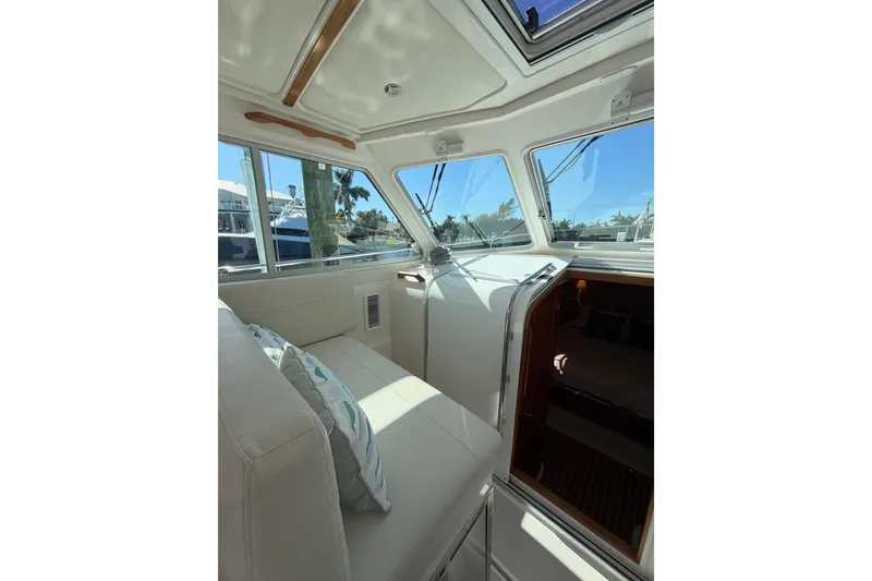 Slide: The Image of Interior of 2023 Back Cove 340 boat with plush seating and large windows. - 16