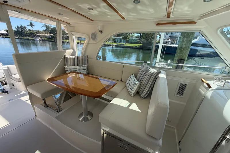 Slide: The Image of 2023 Back Cove 340 yacht interior with elegant seating and waterfront view. - 19