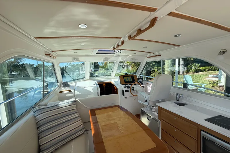 Slide: The Image of Interior of 2023 Back Cove 340 boat with helm, seating, and kitchenette. - 21