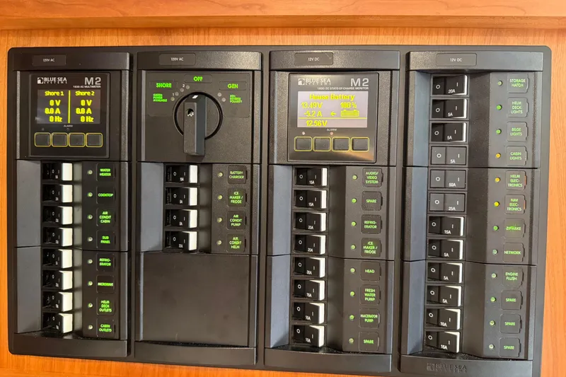 Slide: The Image of Electrical control panel on a 2023 Back Cove 340 boat, featuring Blue Sea Systems displays. - 31