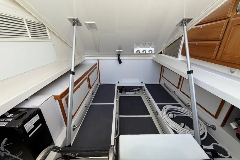 Slide: The Image of 2023 Back Cove 340 interior storage area with organized compartments and equipment. - 37