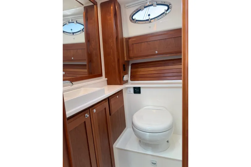 Slide: The Image of 2023 Back Cove 340 yacht bathroom with wooden cabinetry and modern fixtures. - 8