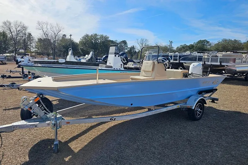 Slide: The Image of 2026 G3 Bay 17 boat on trailer, displayed outdoors with other boats. - 2