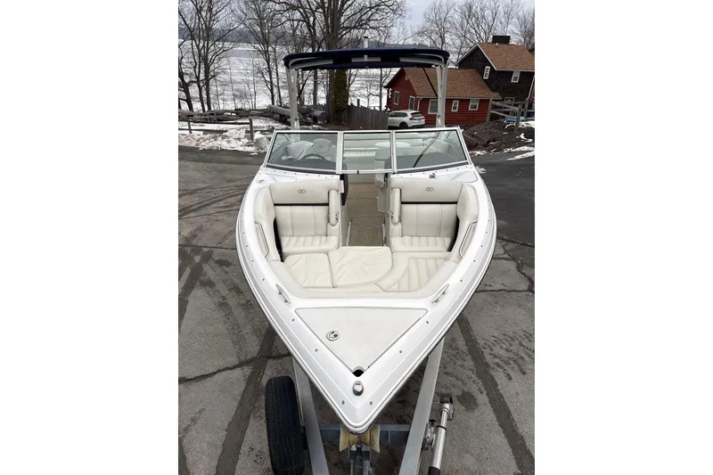 Slide: The Image of 2015 Cobalt R5 boat with white interior, parked near a snowy lakeside. - 10