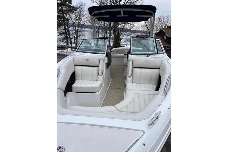 Slide: The Image of 2015 Cobalt R5 boat with white interior, docked near a snowy lakeside. - 11