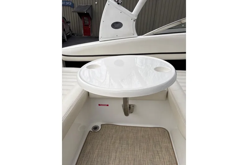 Slide: The Image of 2015 Cobalt R5 boat interior with white seating and round table. - 12