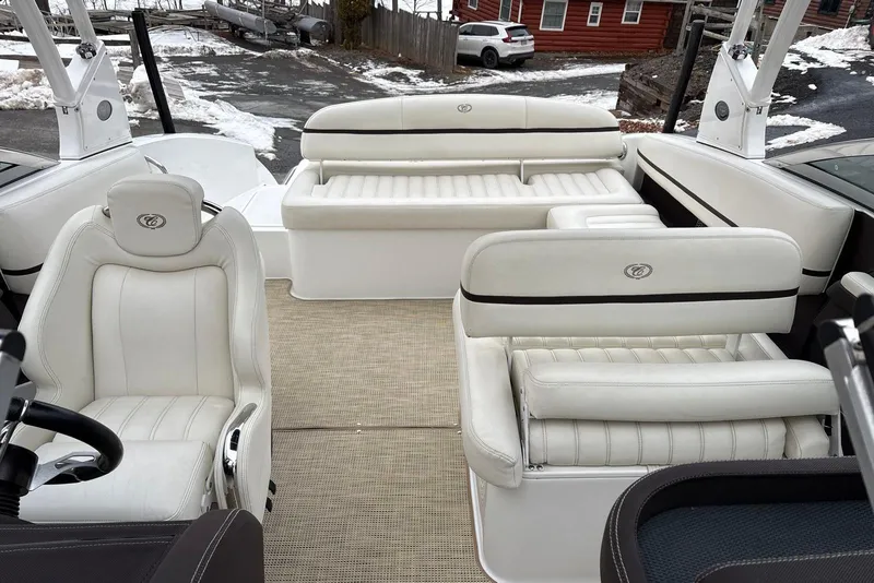 Slide: The Image of Interior of a 2015 Cobalt R5 boat with white leather seating and steering wheel. - 15