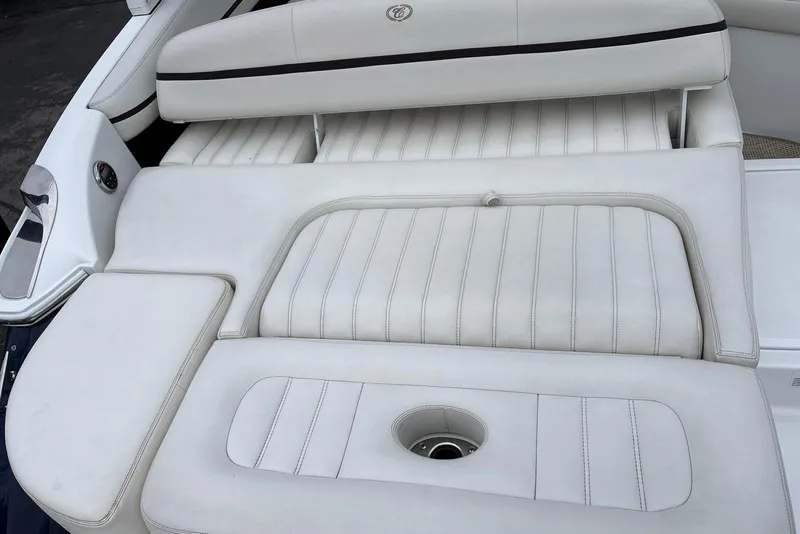Slide: The Image of White leather seating on a 2015 Cobalt R5 boat, featuring sleek design and stitching. - 16